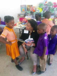 Dr. eneid Francis reads one on one with the students giving personal attention. The institution currently has four teachers.