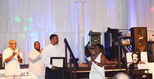  Shown are Mark Marshall, JJS President and JJS Interim Vice President J. Valentine presenting scholarship to recipient Jacinto Sims, II and Tariq Adkins. Standing in the background is Jacksonville Jazz Society President Na’im Rashid.